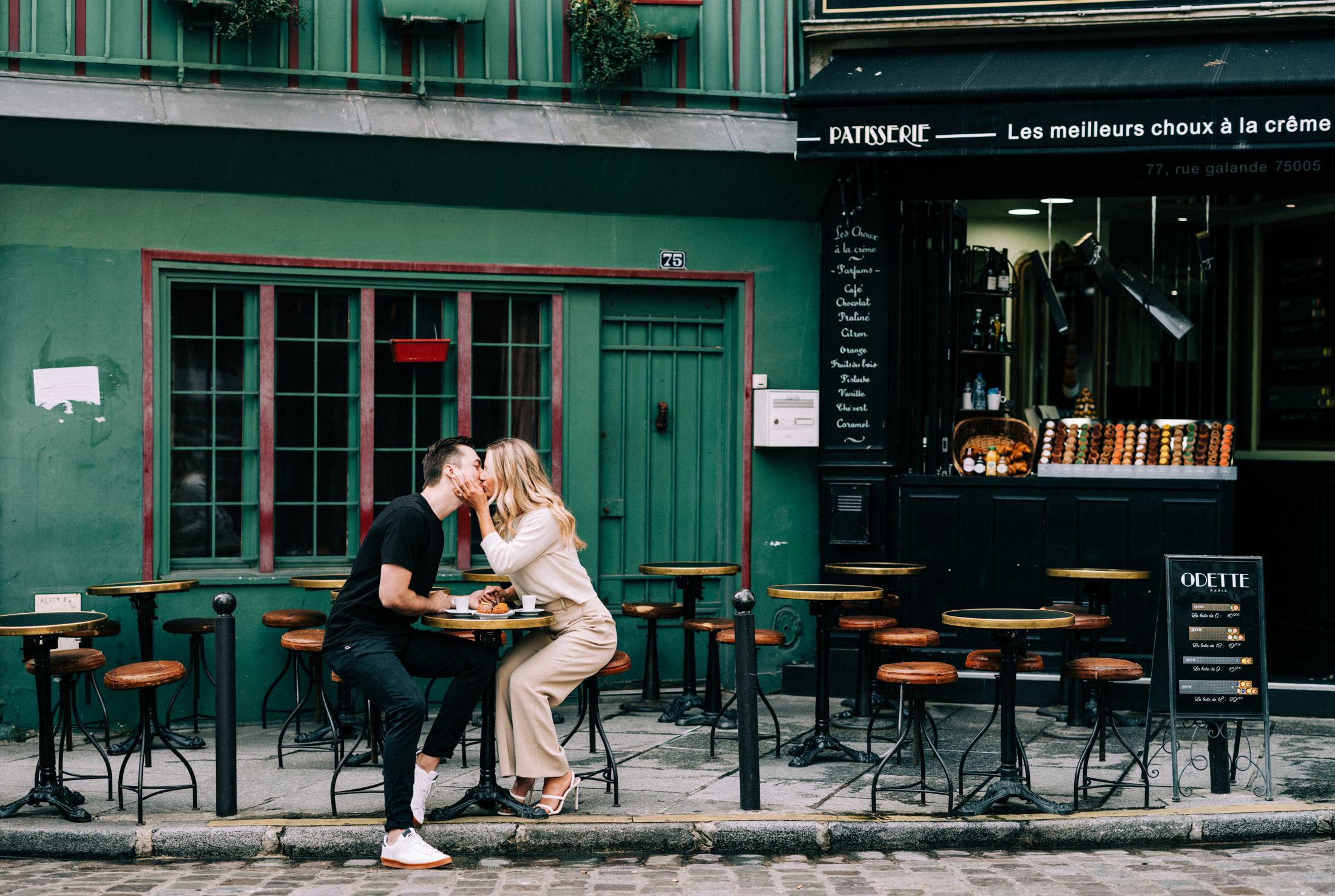 cute young newly engaged couple kiss passionately at a green patisserie in paris france