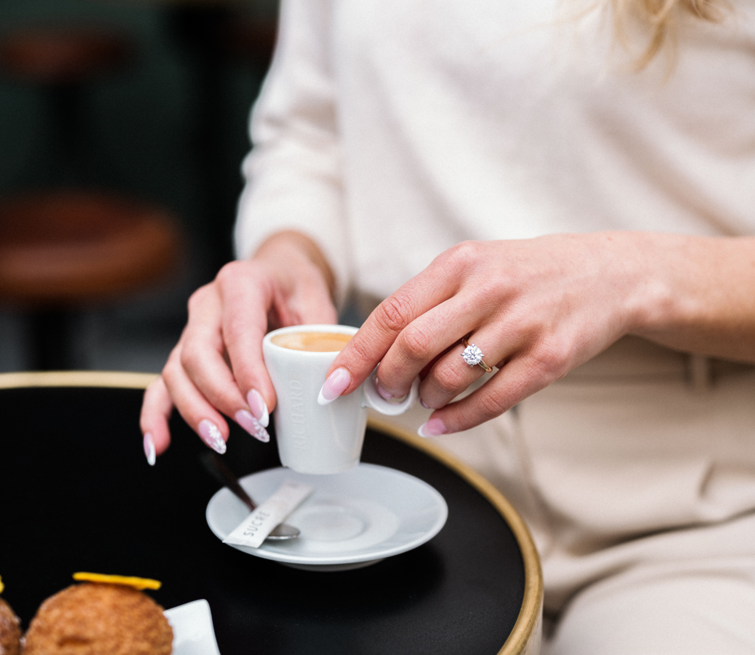 newly engaged woman shows off her engagement ring in paris