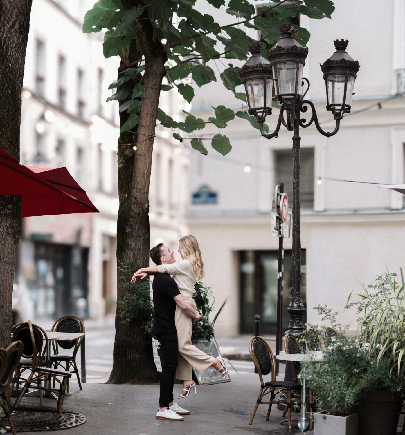 cute young newly engaged couple dance in charming neighborhood in paris