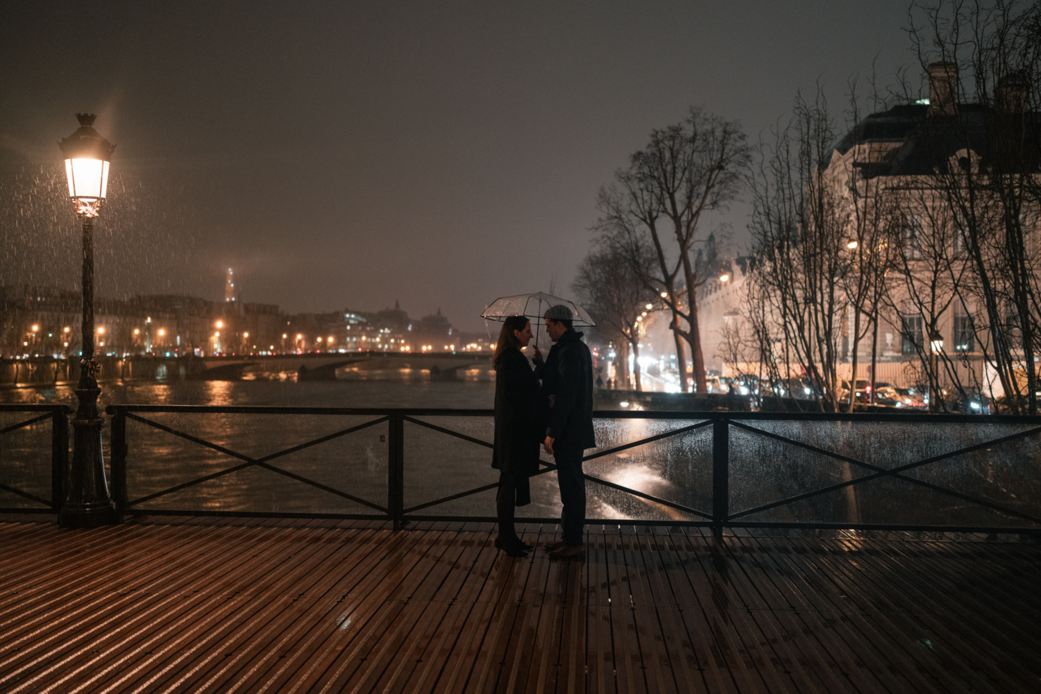 man talks to woman on bridge in paris right before proposal