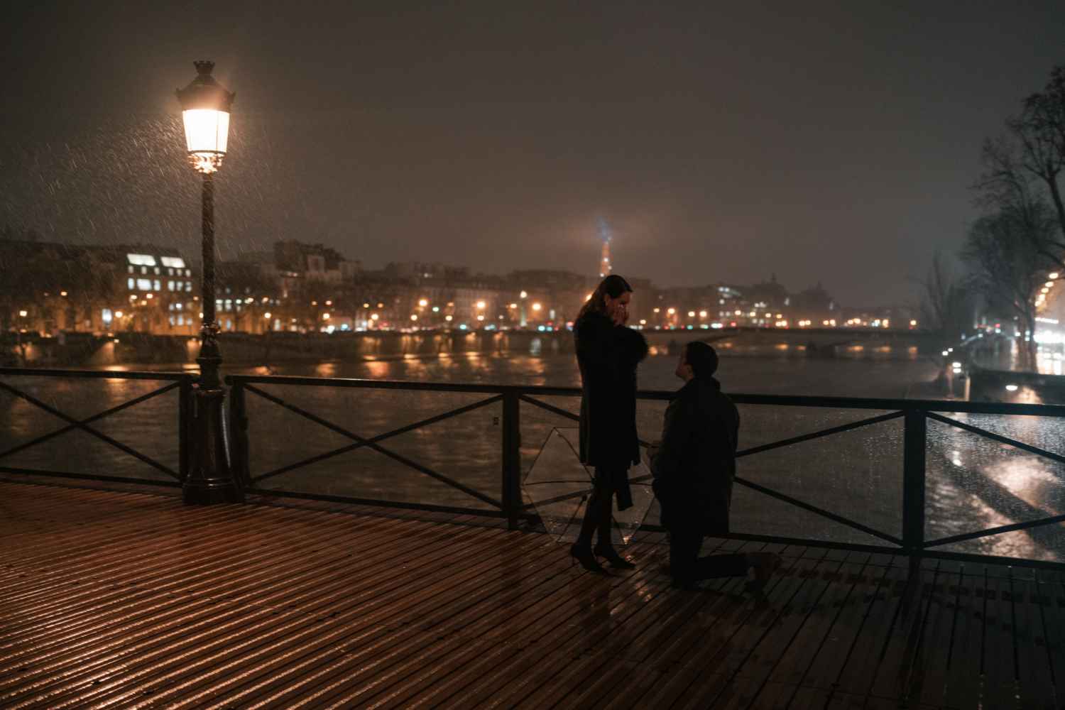 woman becomes emotional as man asks her to marry him in paris at night