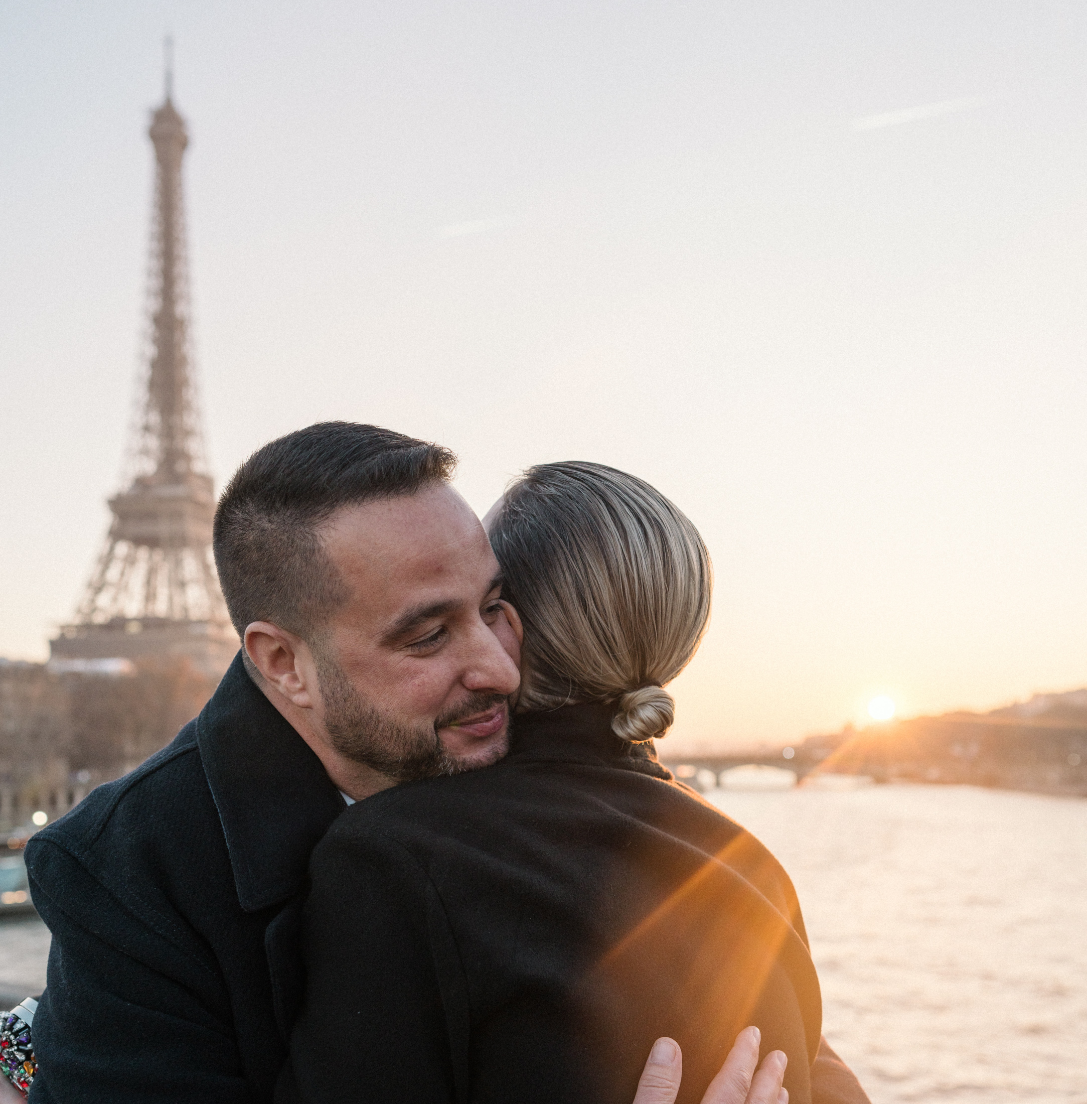 man hugs woman after proposing in paris france