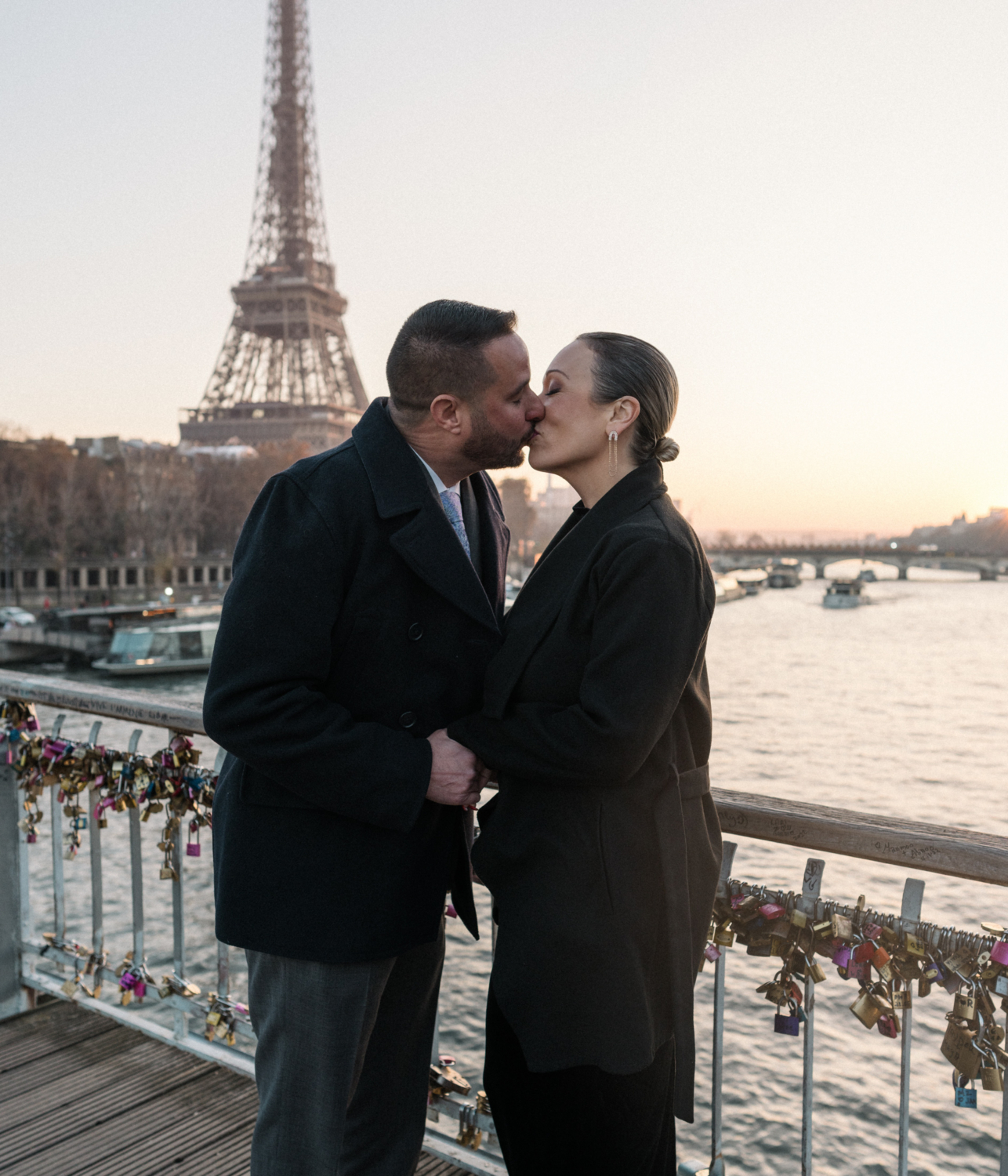 newly engaged couple kiss on the passerelle debilly bridge in paris