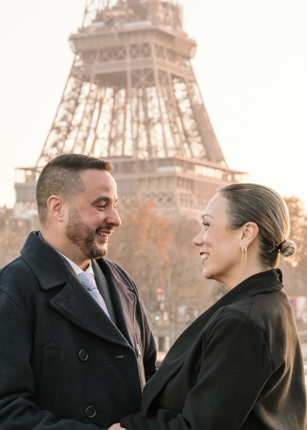 mature couple smile after their engagement with view of eiffel tower in paris