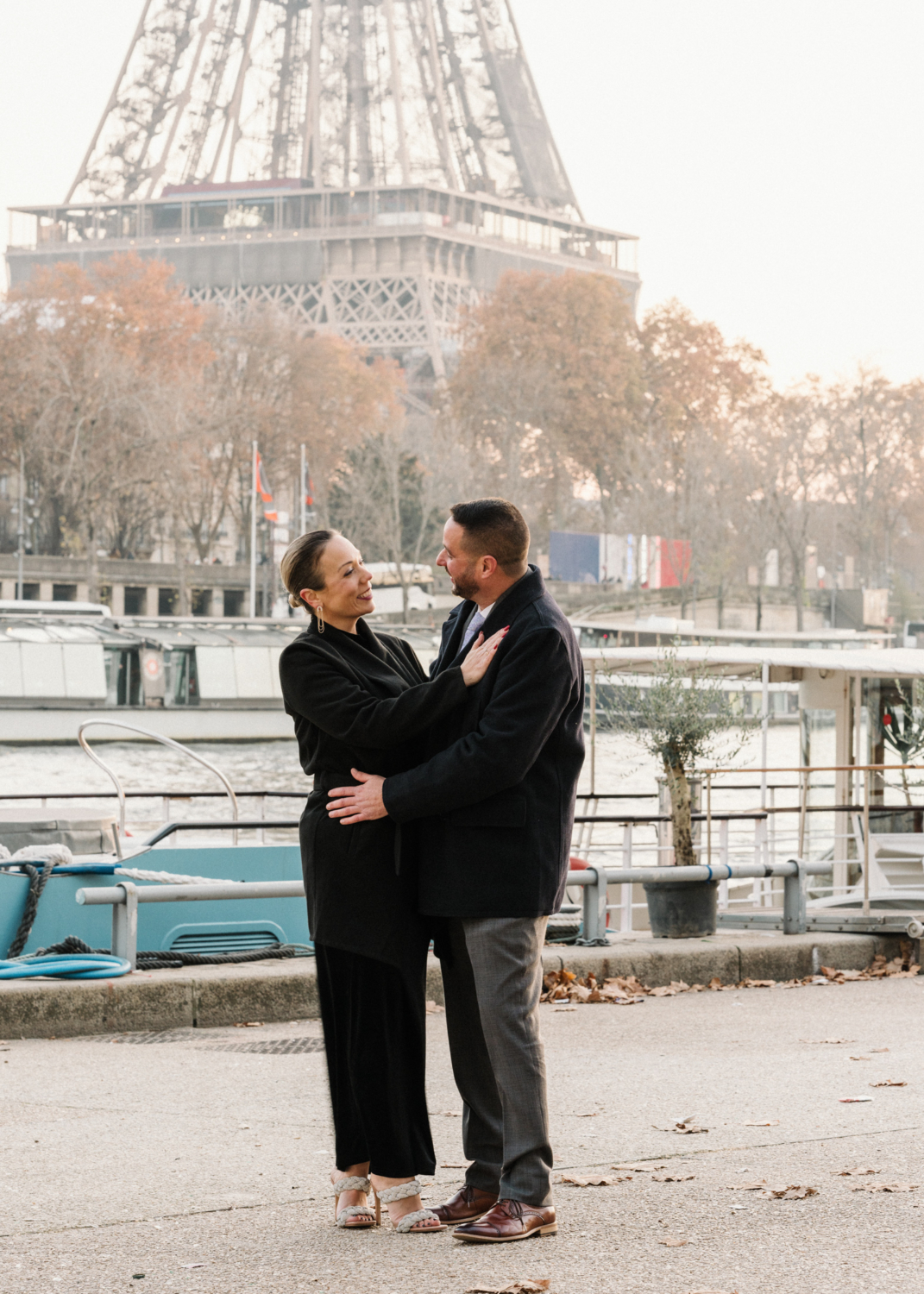 mature couple embrace in paris with view of the eiffel tower