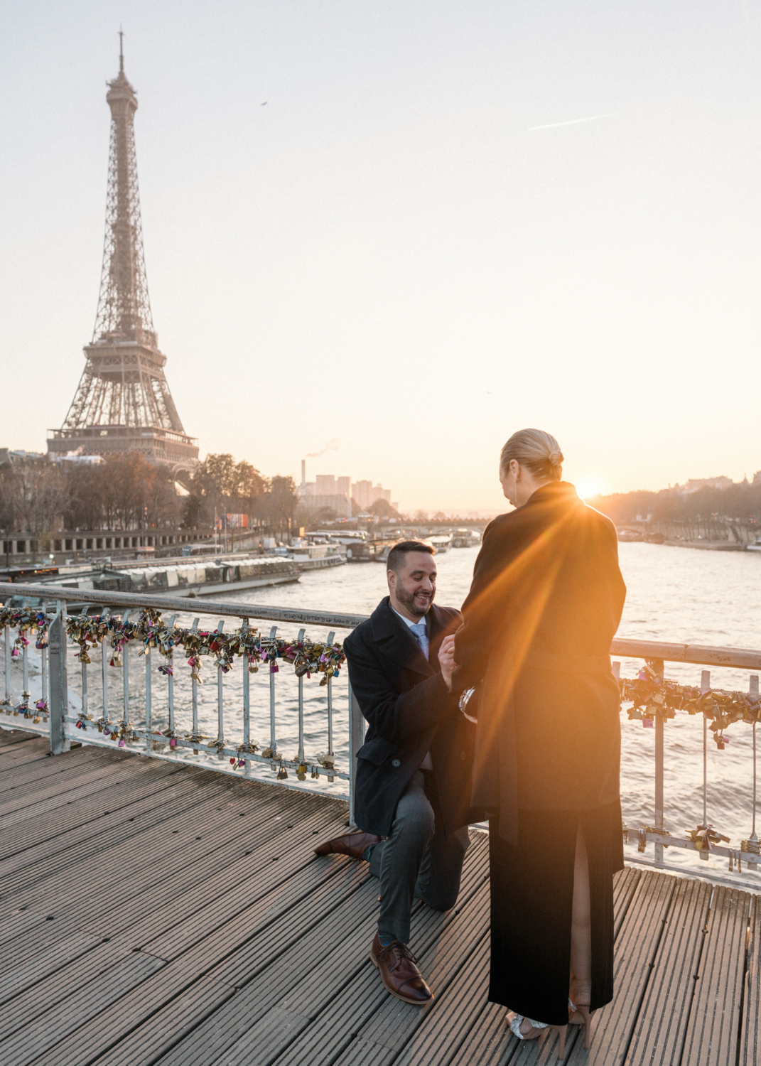 man proposes to woman on passerelle debilly in paris and puts ring on finger