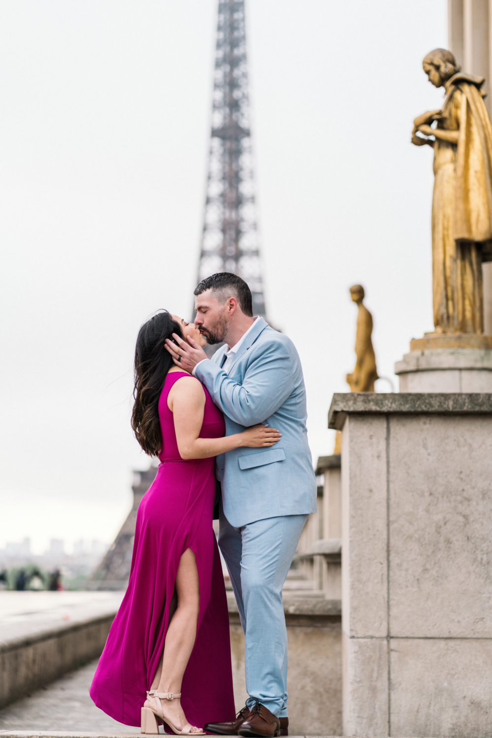 man passionately kisses woman with view of eiffel tower in paris