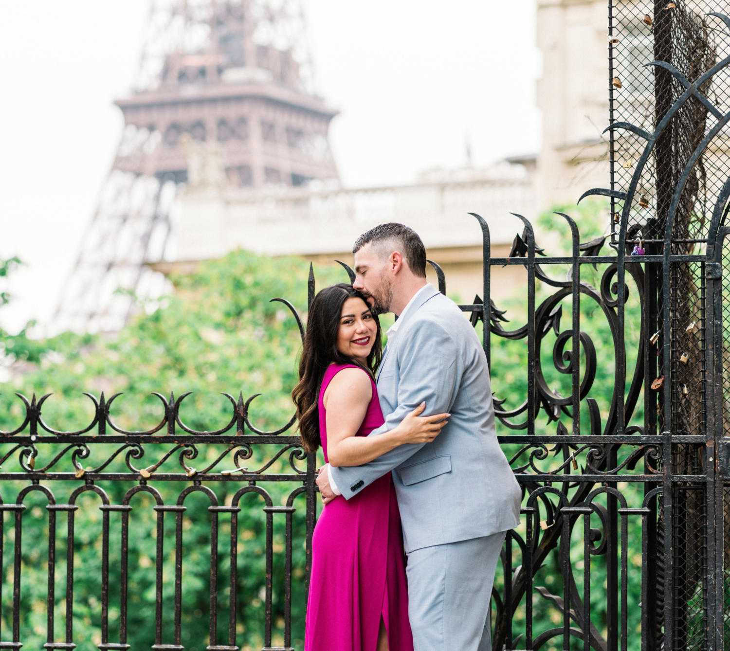 wife smiles as husband kisses her head in paris france