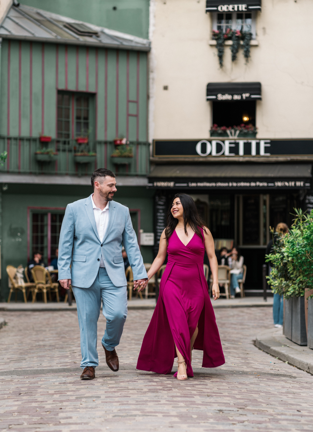 cute couple laugh and walk in paris france