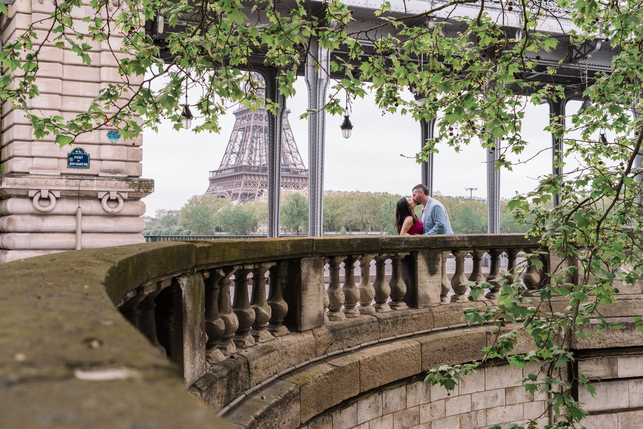 couple passionately kiss with view of eiffel tower in background in paris