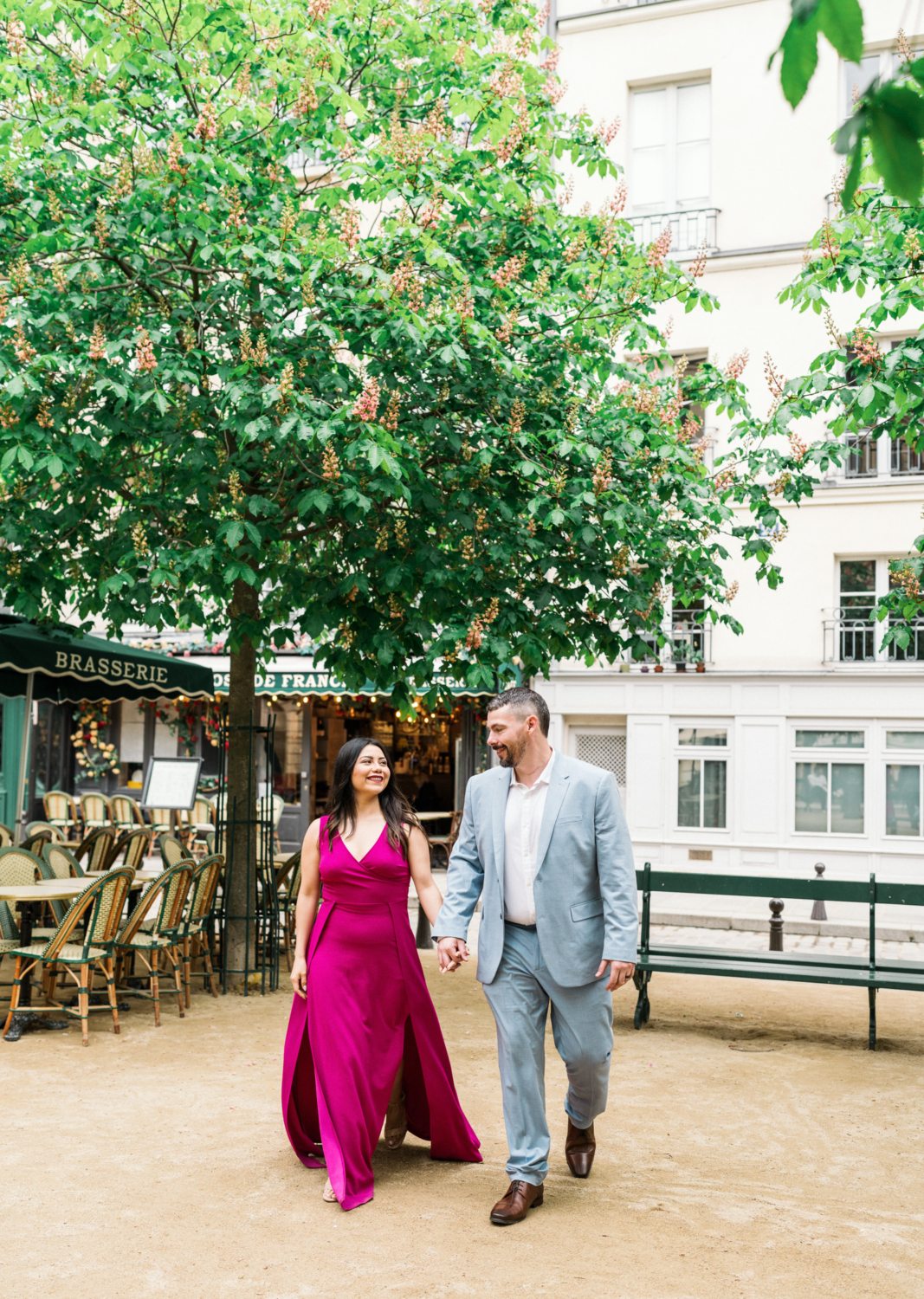 married couple walk hand in hand in spring at place dauphine paris