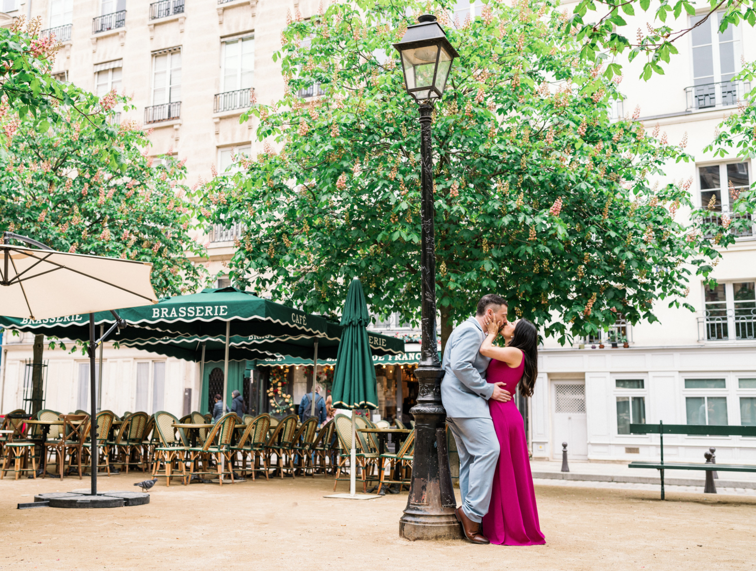 couple passionately kiss at place dauphine in paris