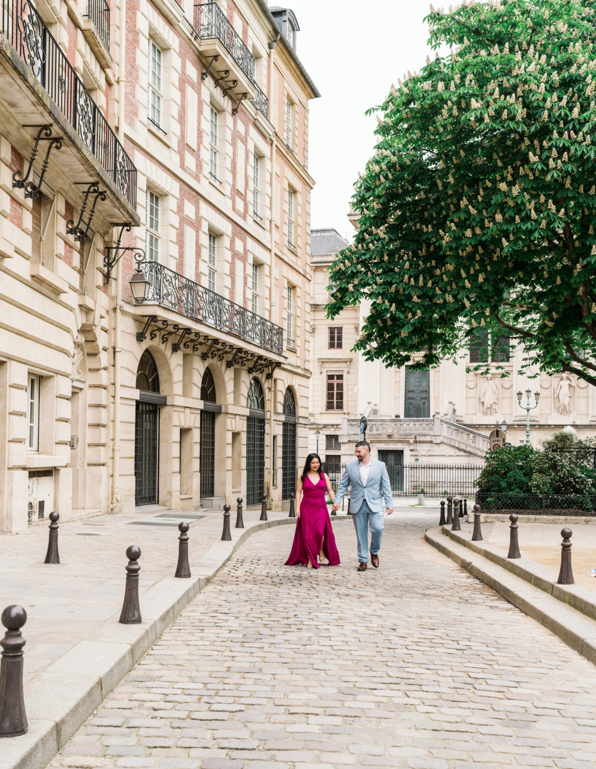 cute couple walk at place dauphine in paris