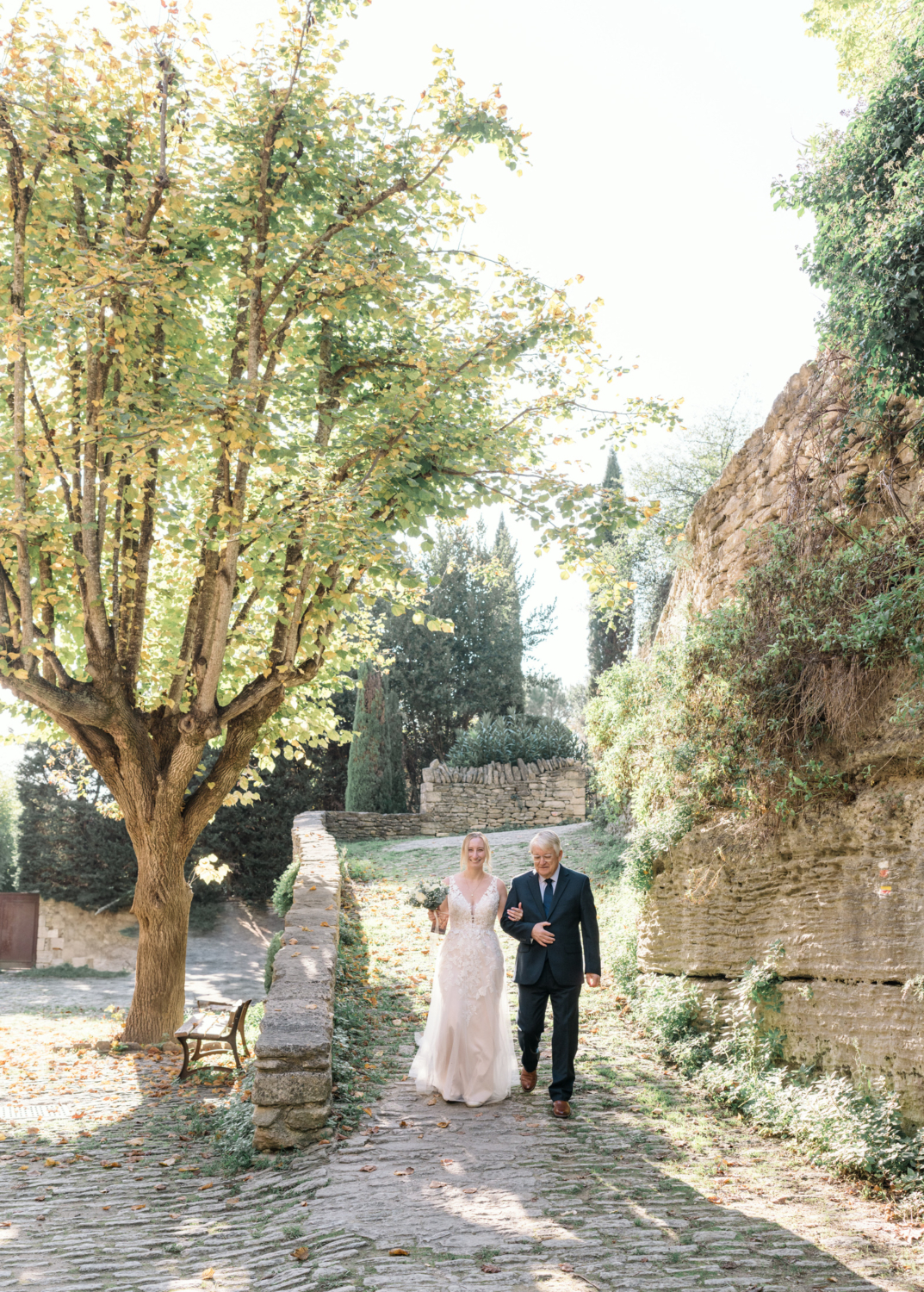 bride's father walks her to her wedding in gordes france provence