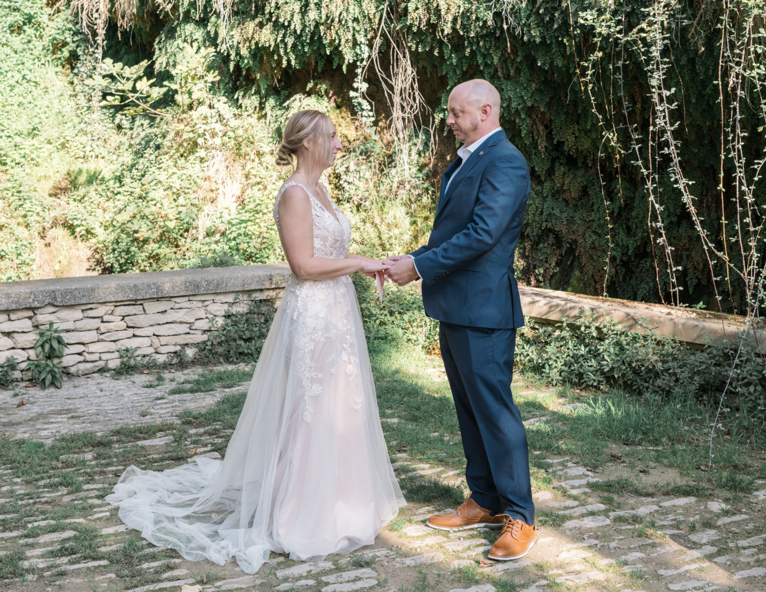 bride and groom hold hands during wedding ceremony in gordes france provence