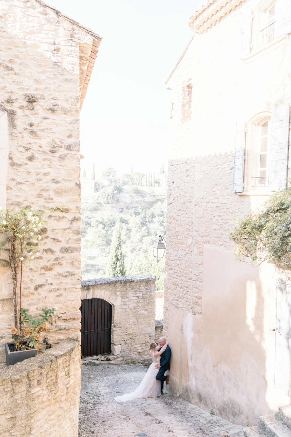 bride and groom embrace in charming gordes france provence