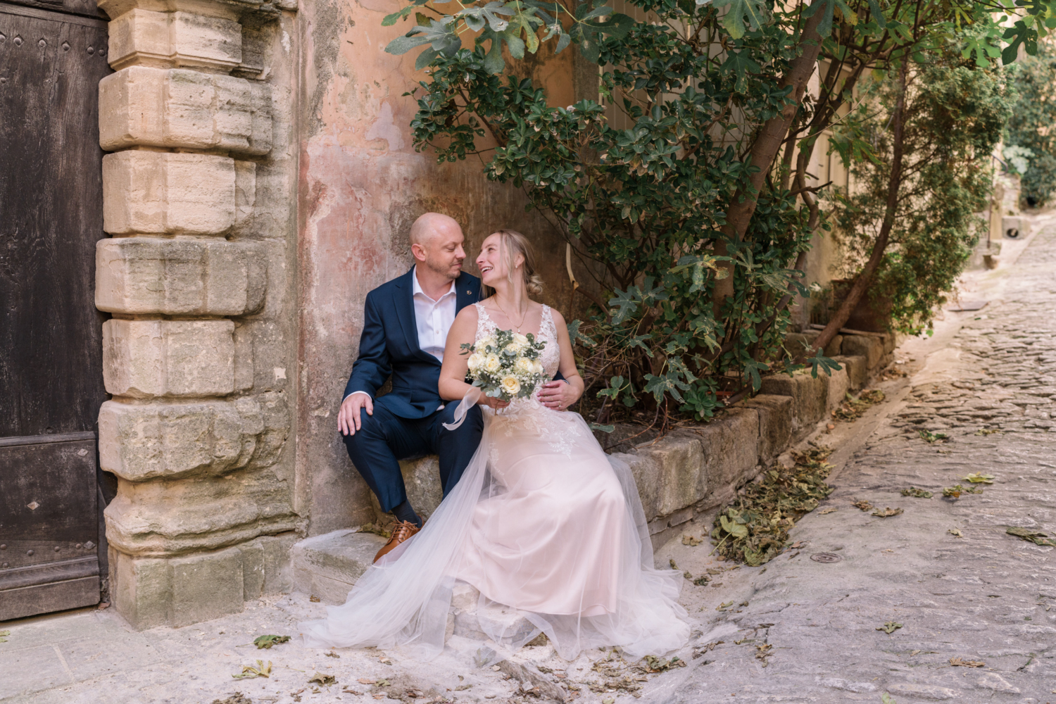 bride and groom have a moment on the streets of gordes france