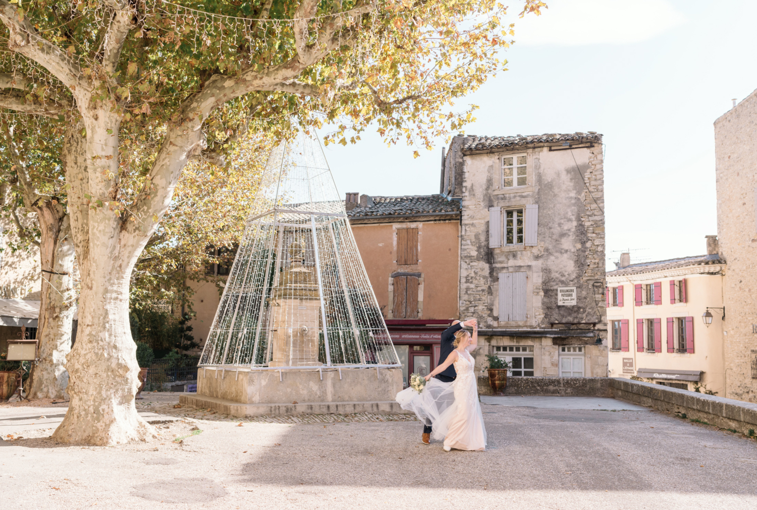 bride and groom dance in the town square of gordes france