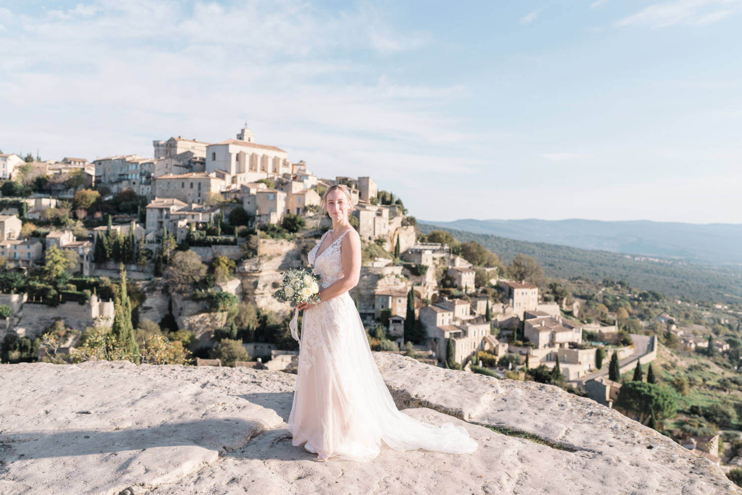 bride poses on her wedding day in gordes france provence