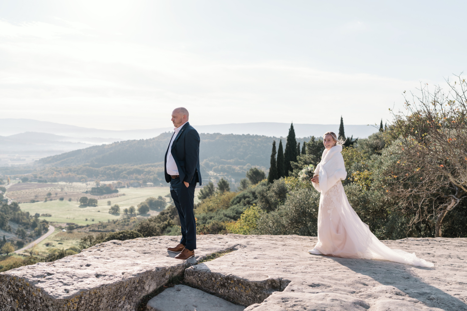 bride prepares to surprise groom on their wedding day in gordes france provence