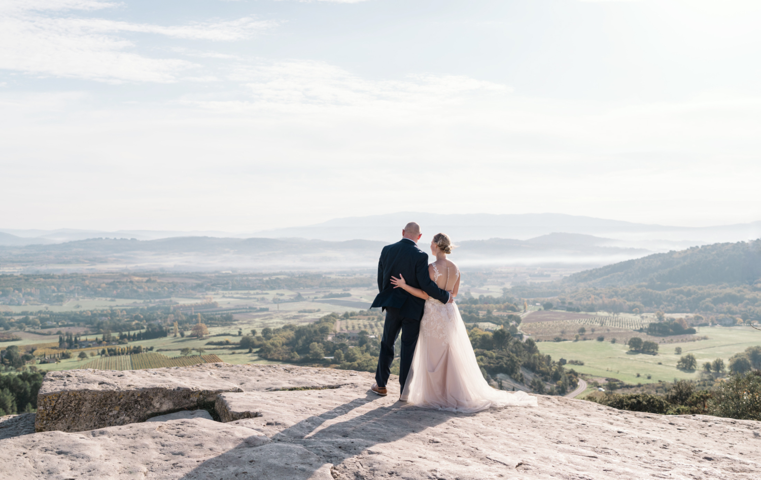 bride and groom look out over landscape in gordes france provence