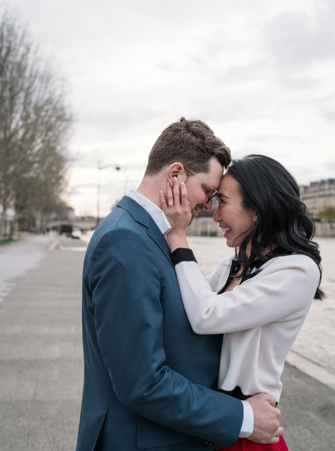 newly engaged couple beam at each other after their engagement in paris