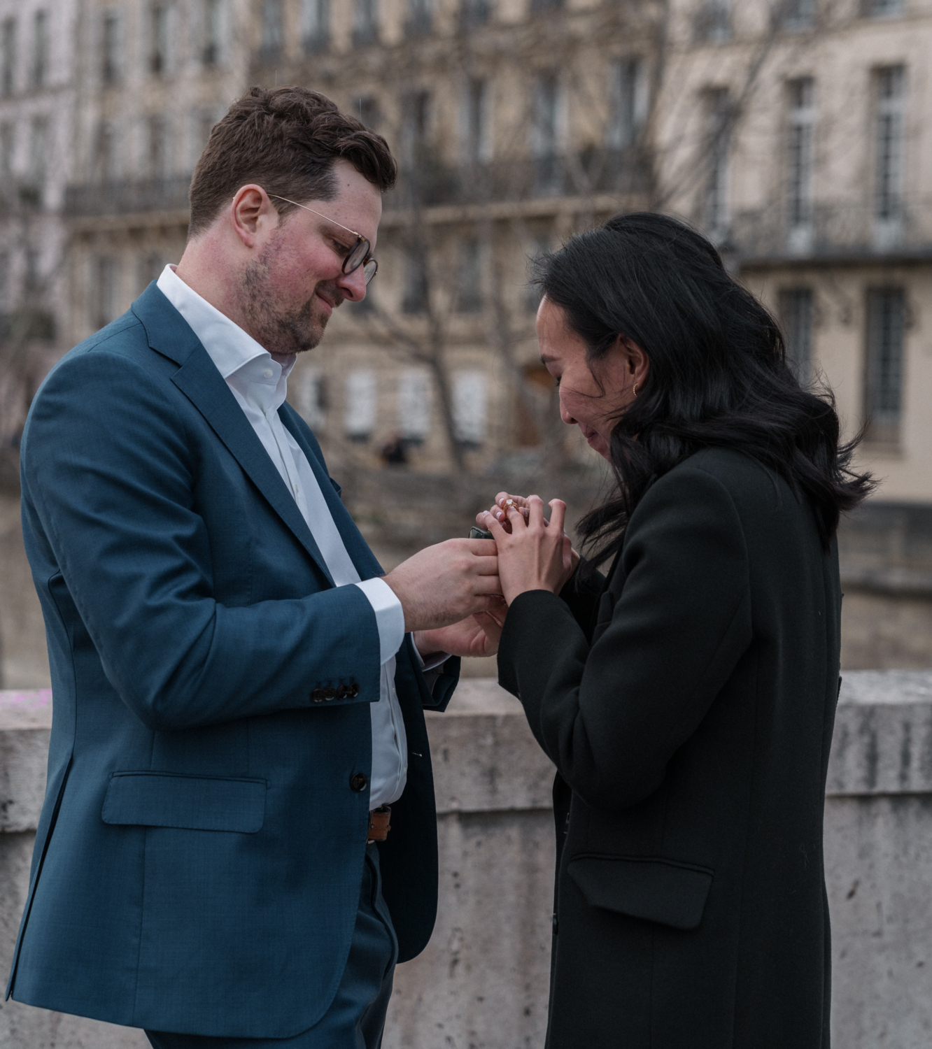 woman puts her new engagement ring in paris france