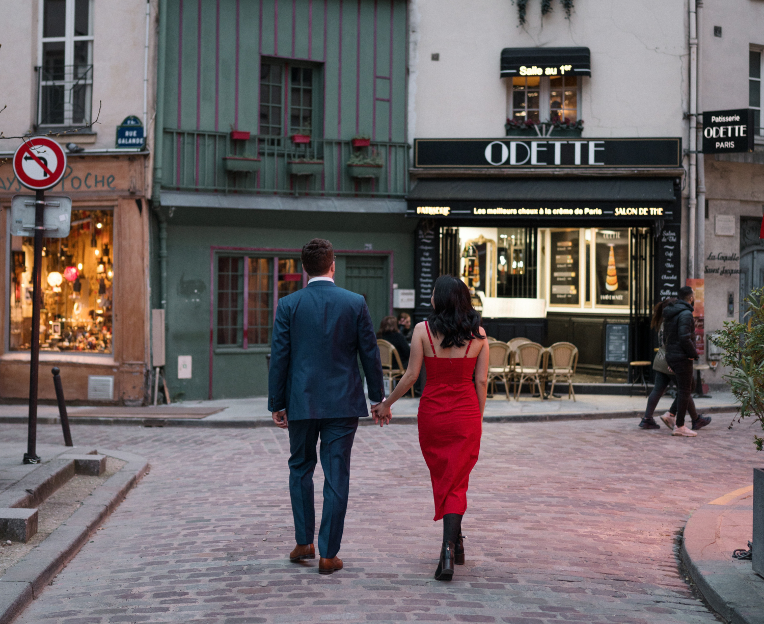 newly engaged couple walk hand in hand in latin quarter in paris