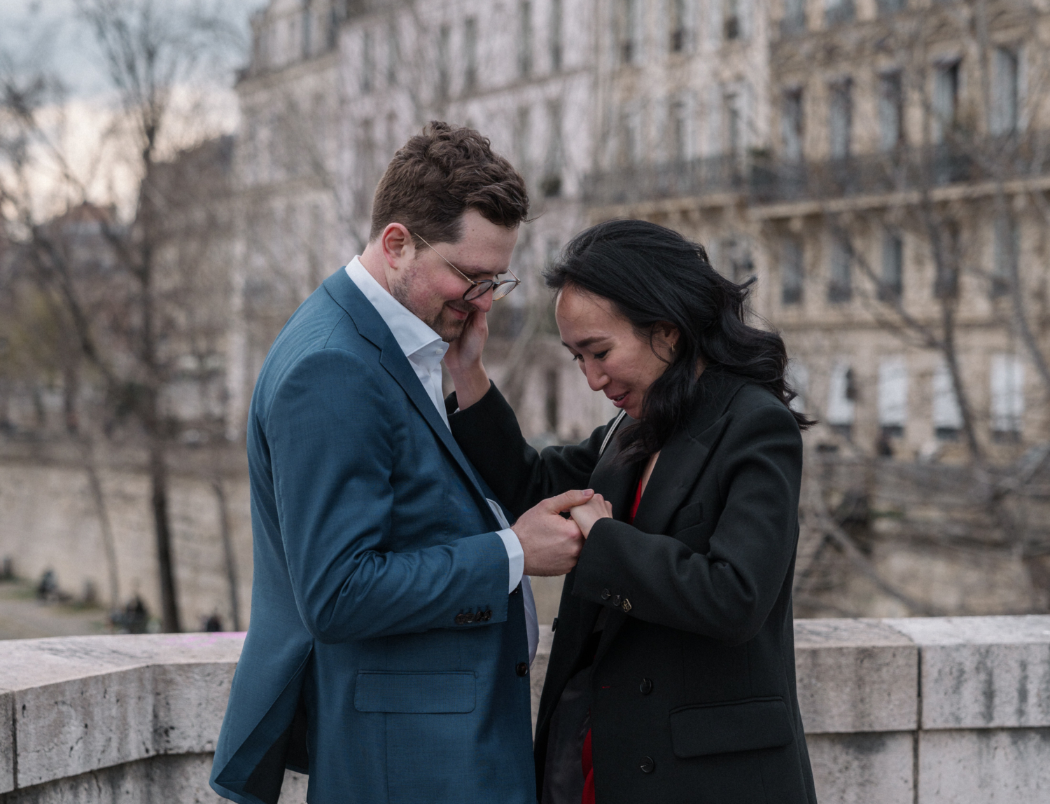 woman looks at new engagement ring in paris