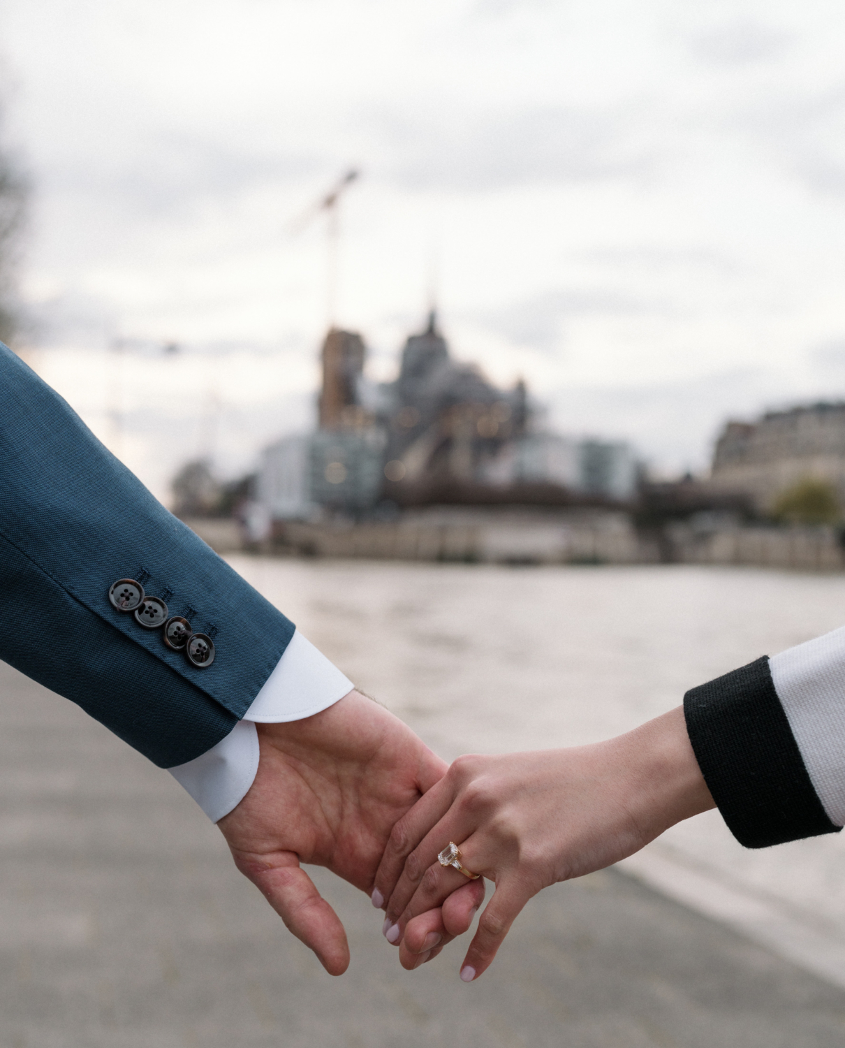 newly engaged couple show off engagement ring in paris