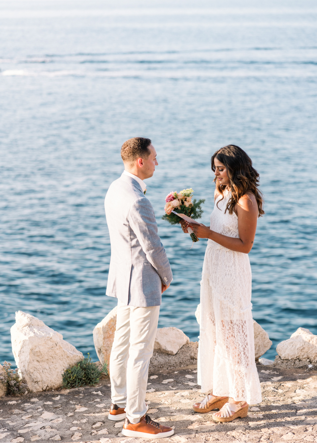 bride reads her vows to groom during their elopement in saint jean cap ferrat france on the french riviera