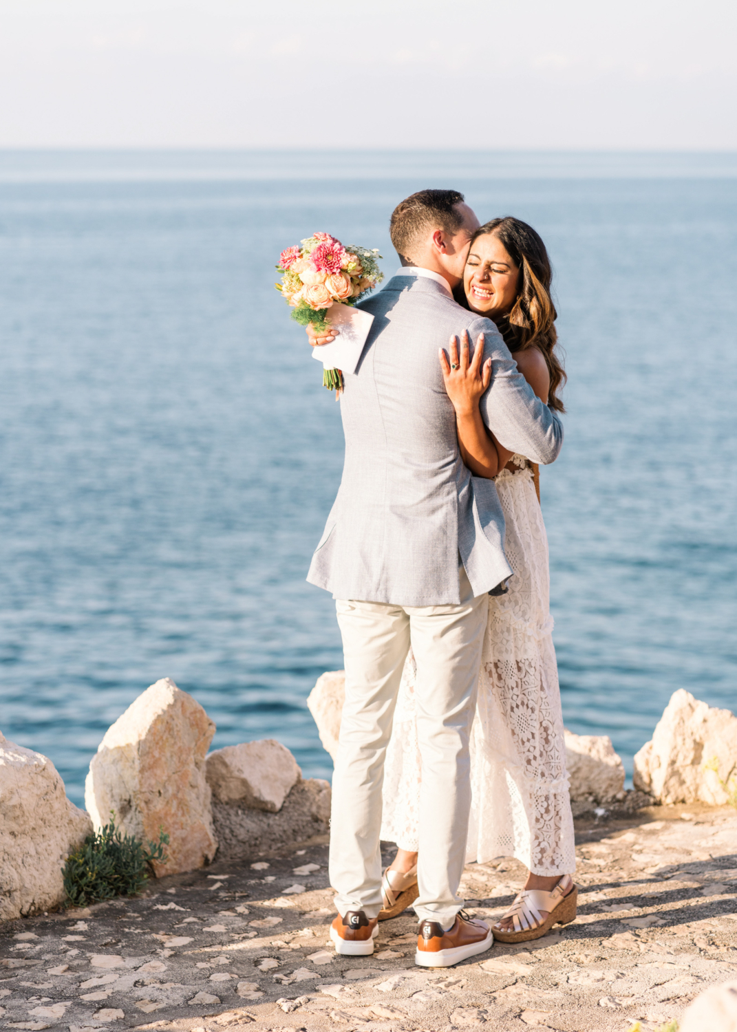 joyful couple embrace after exchanging vow during their elopement in saint jean cap ferrat france on the french riviera