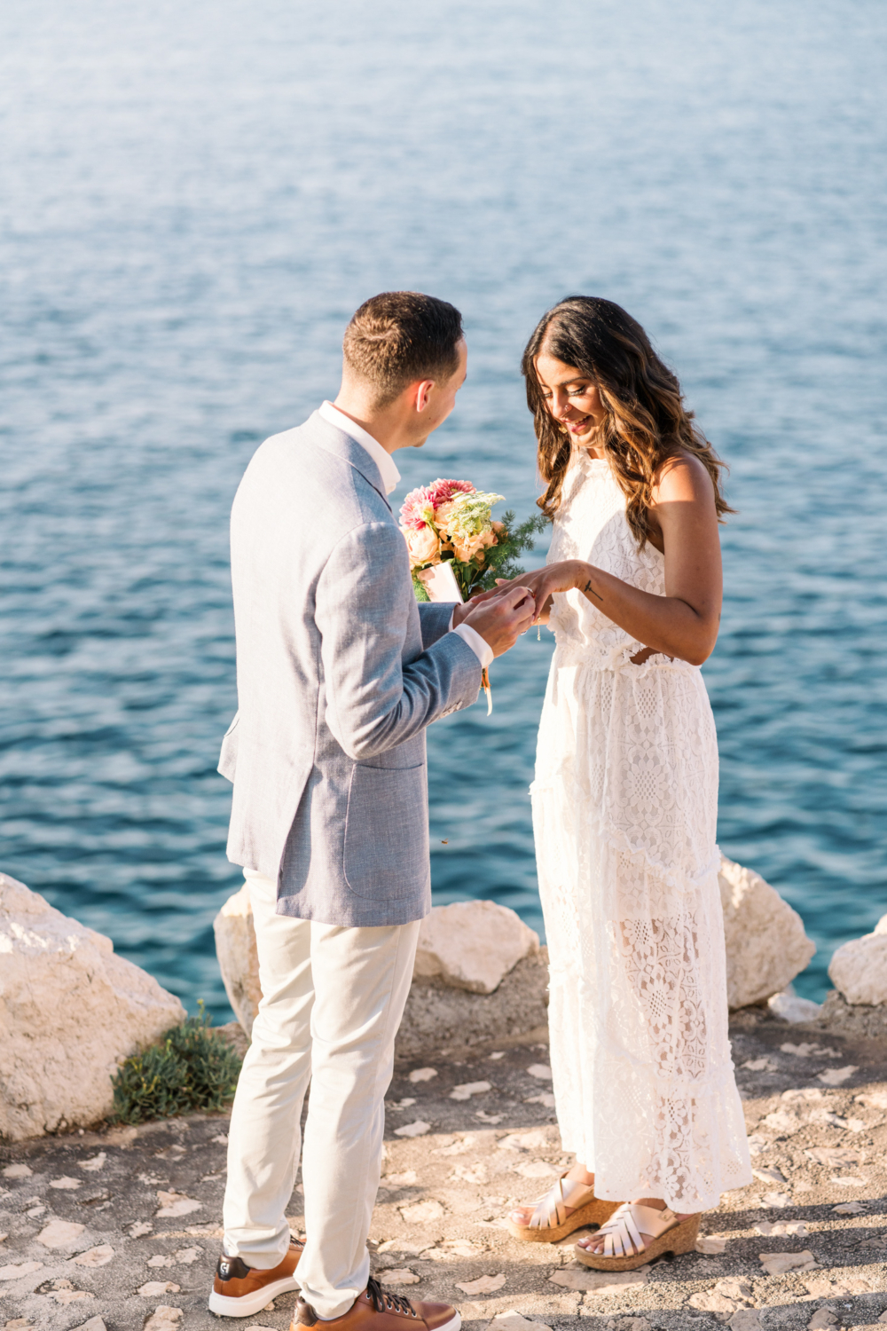 couple exchange rings during their elopement in saint jean cap ferrat france on the french riviera