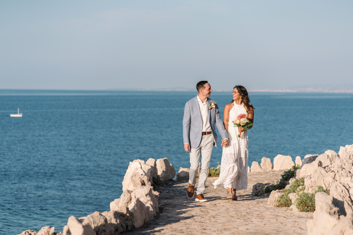 bride and groom laugh and hold hands at their elopement in saint jean cap ferrat france