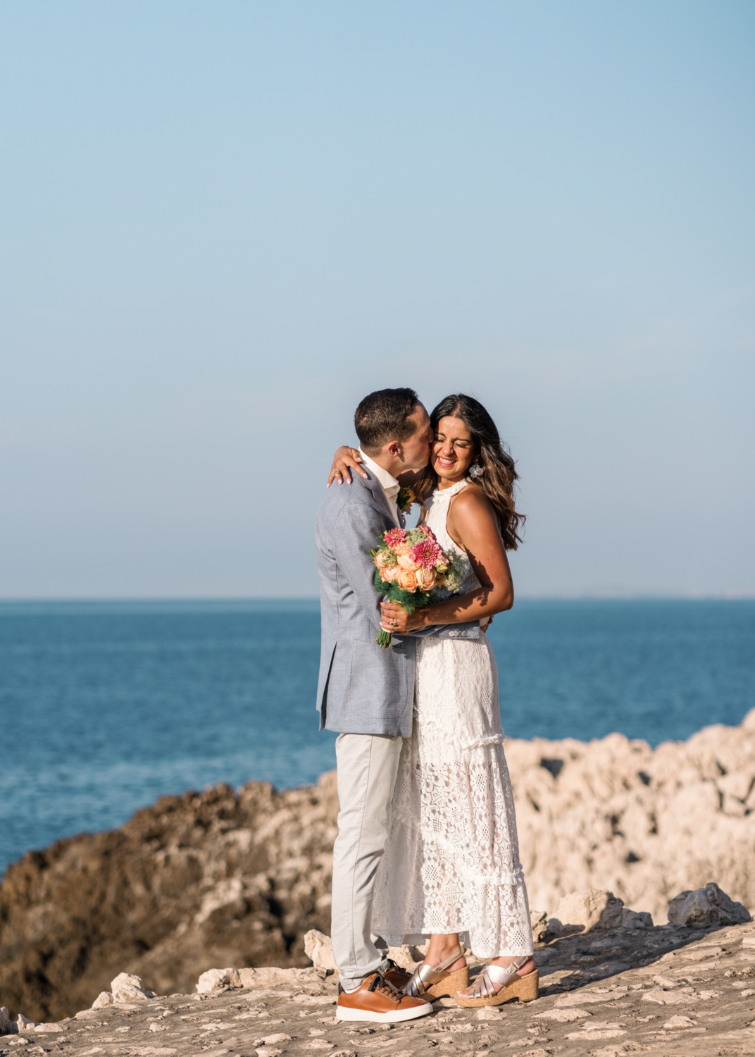 groom kisses bride on cheek during their wedding in saint jean cap ferrat france