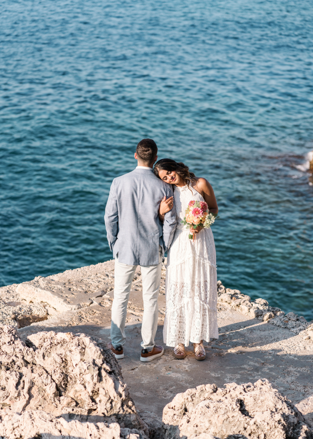 bride puts her head on grooms shoulder with sea view in saint jean cap ferrat france