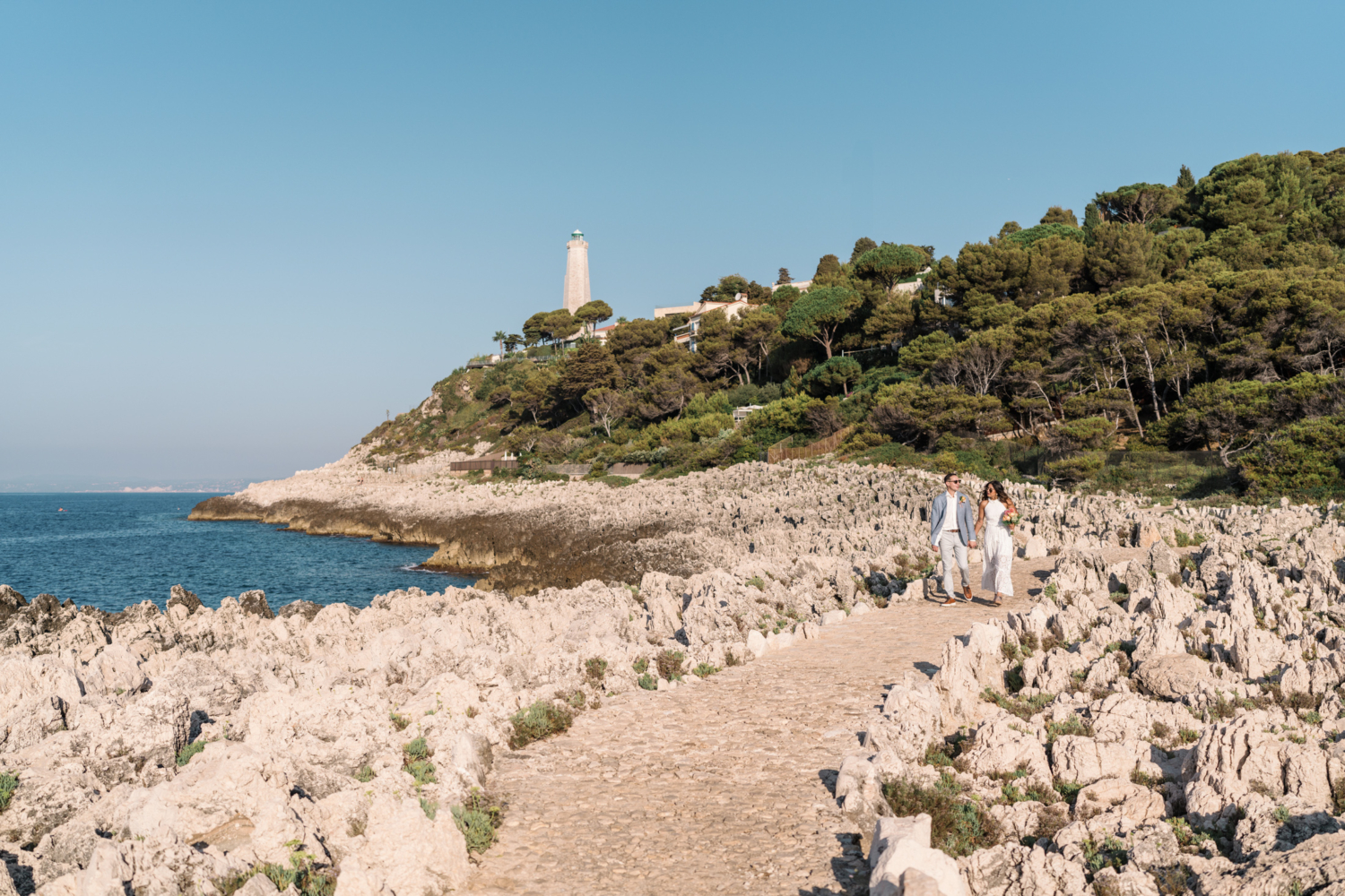 newlywed couple walk along the sea in saint jean cap ferrat france on the french riviera