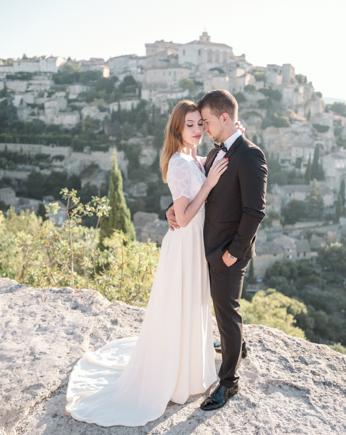 bride and groom pose with beautiful view in gordes france