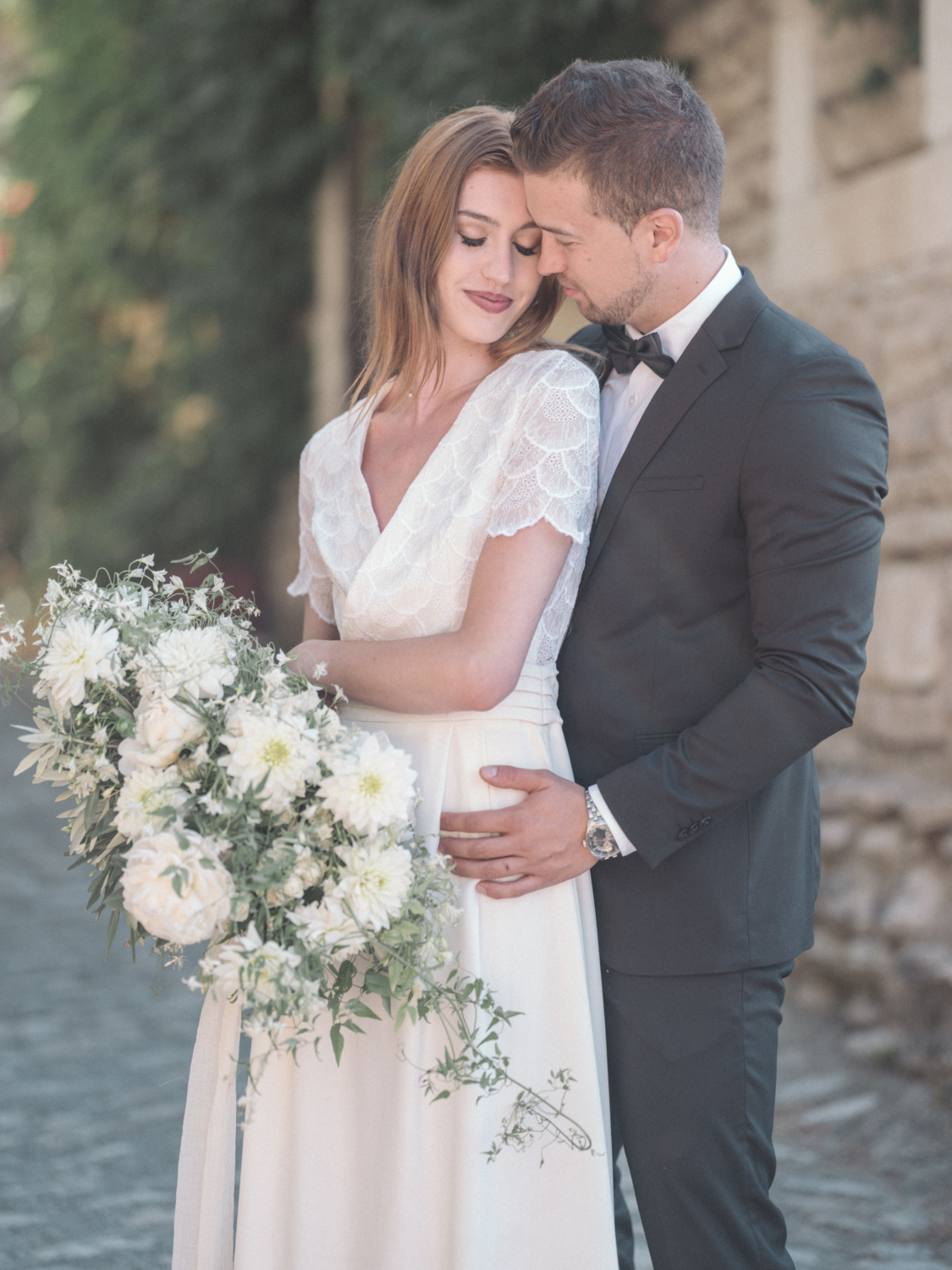 bride smiles as she stands with groom in gordes france