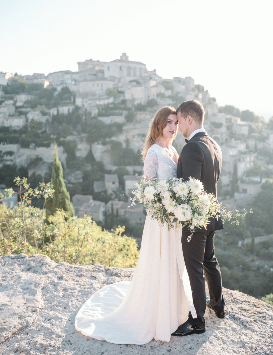 bride and groom embrace with beautiful view in gordes france