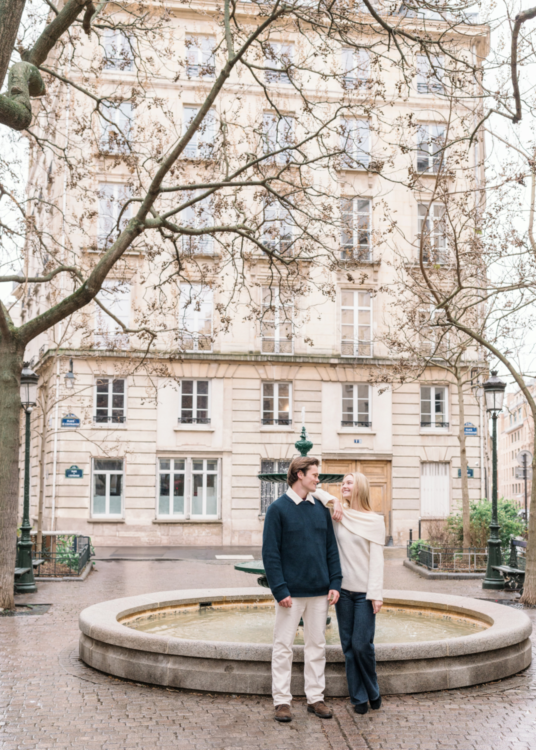 newly engaged couple pose at place de contrescarpe in paris