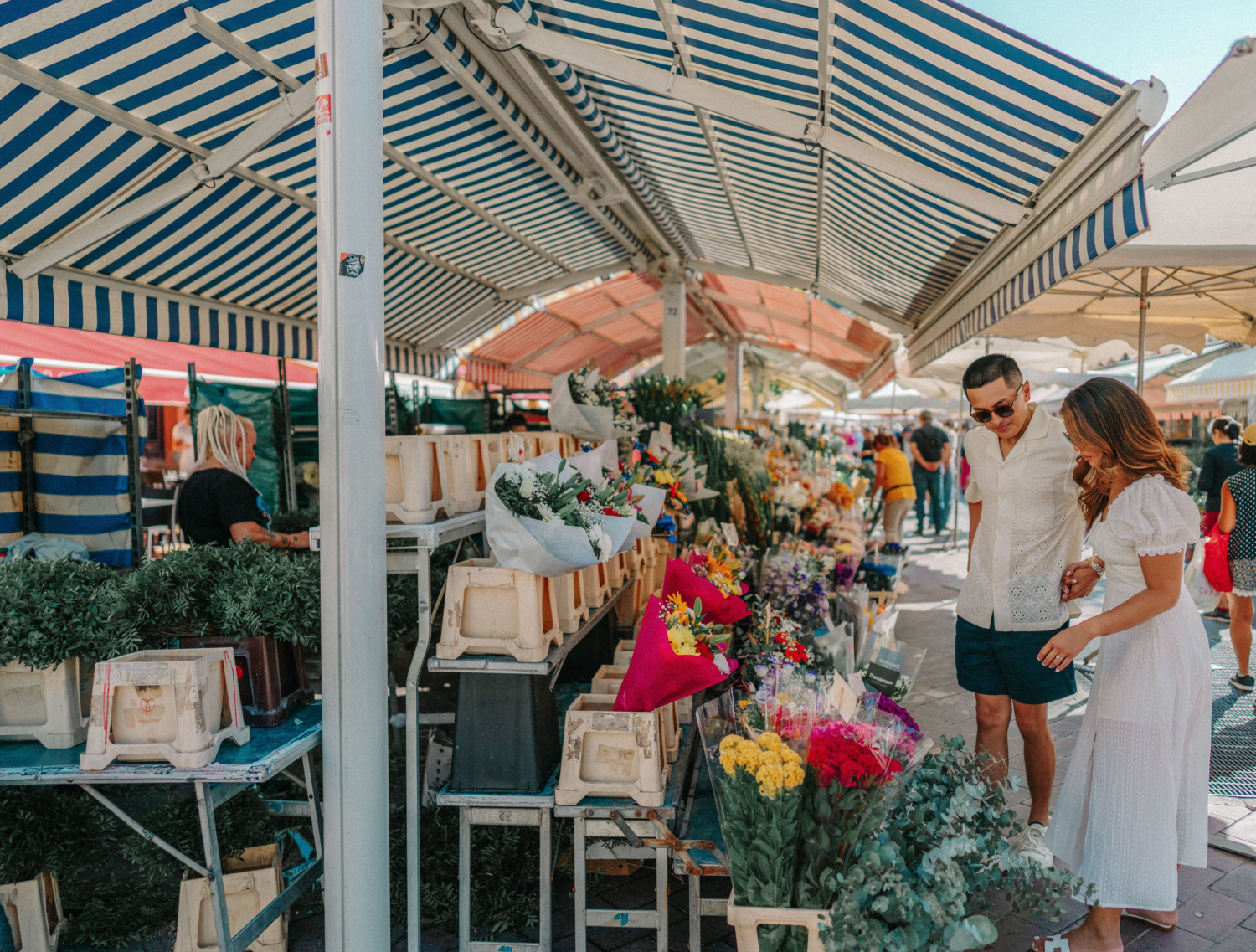 couple walk through cours saleya in nice france