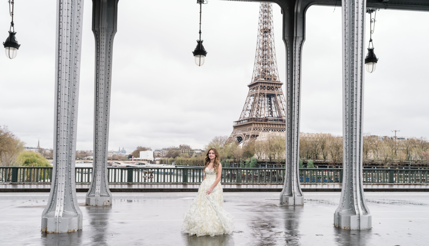 young woman dances in quinceanera gown with view of eiffel tower