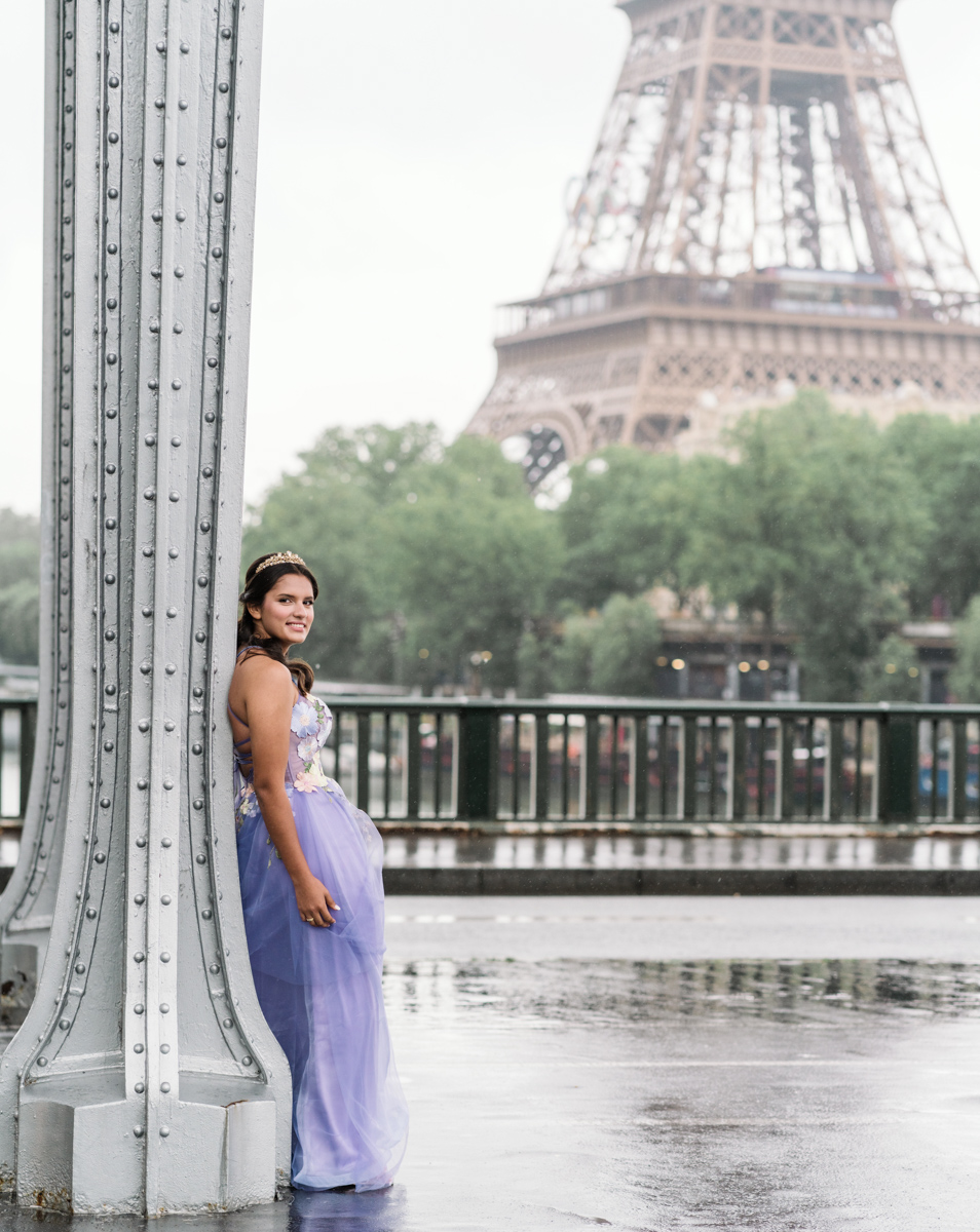 young lady poses in paris on her quinceanera with view of eiffel tower