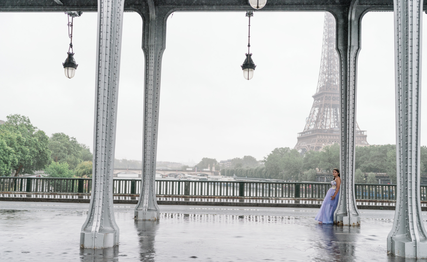 young lady poses with view of eiffel tower in ball gown in paris