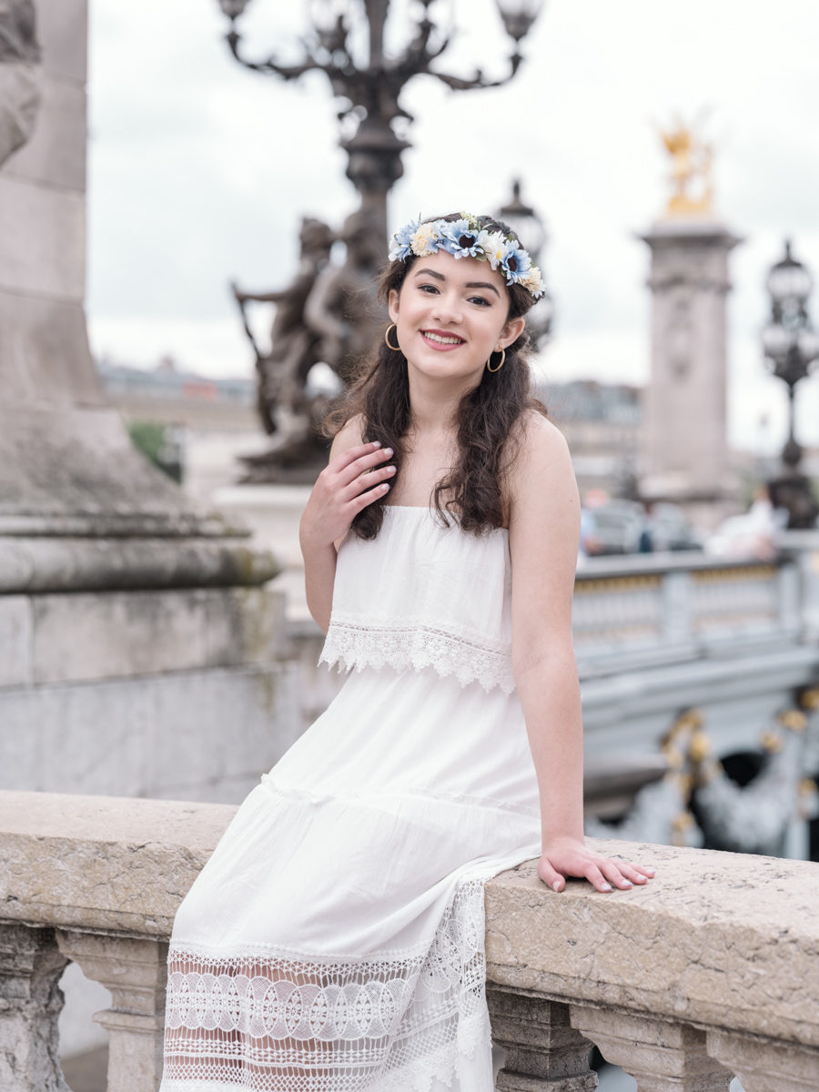 young woman smiles on the pont alexandre in paris for her quinceanera photoshoot