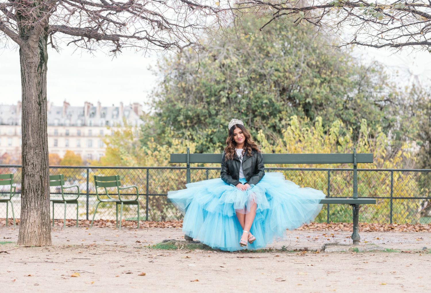 young woman wears quinceanera crown in tuileries gardens in paris