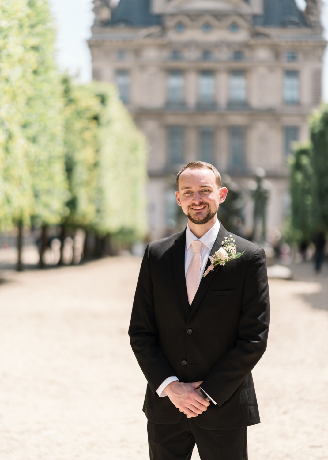 handsome groom poses in paris