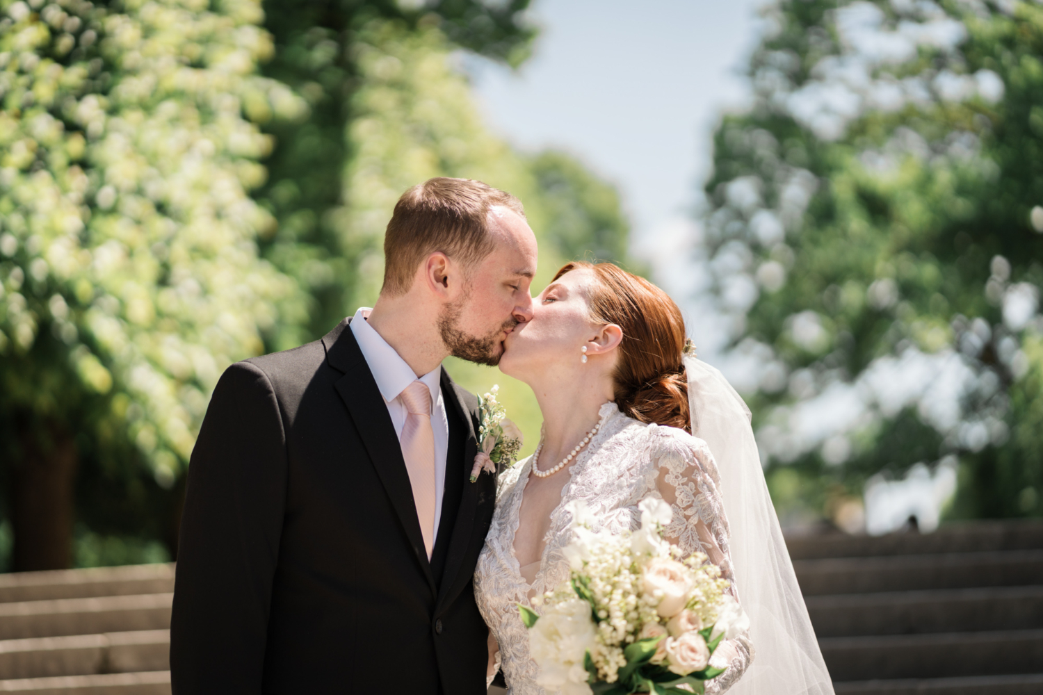 bride and groom kiss passionately in paris on their wedding day