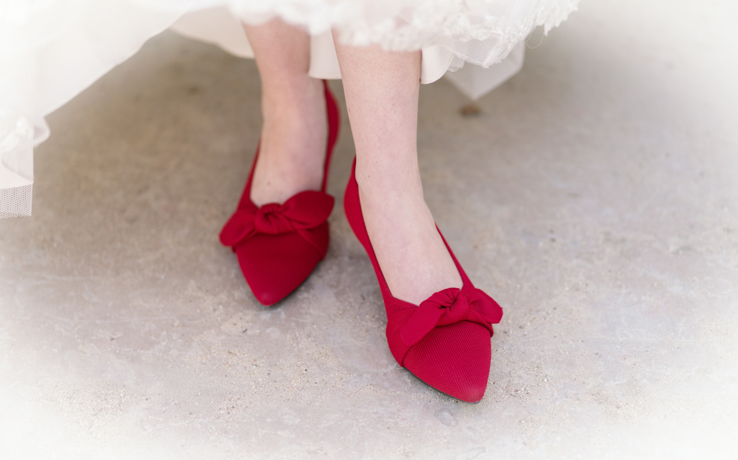 bride wears bright red shoes on her wedding day in paris